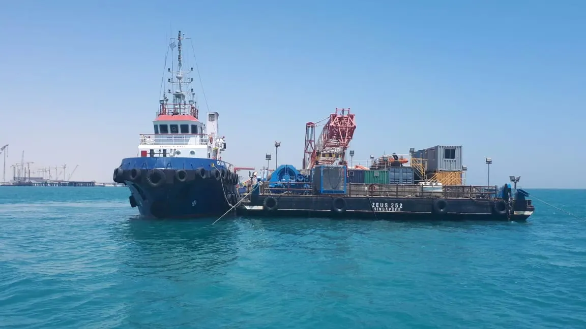 Tug and barge at sea