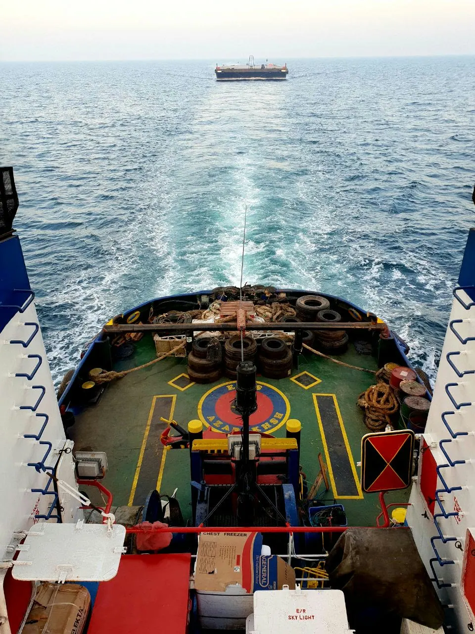 View over a vessel's stern deck and wake